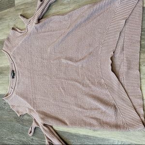 Woman’s sweater with decorative rips on sleeves